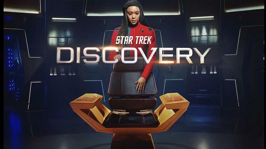 Captain Michael Burnham steht hinter dem Kapitänssitz, im Vordergrund das Logo von Star Trek: Discovery